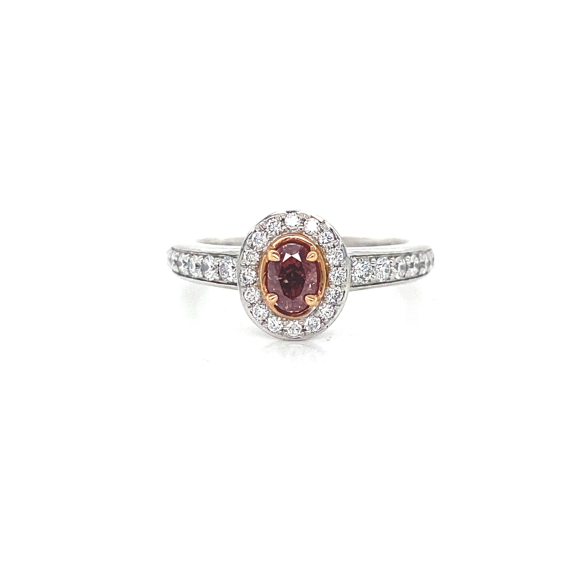 An oval pink gemstone engagement ring with a diamond halo and diamond-set band